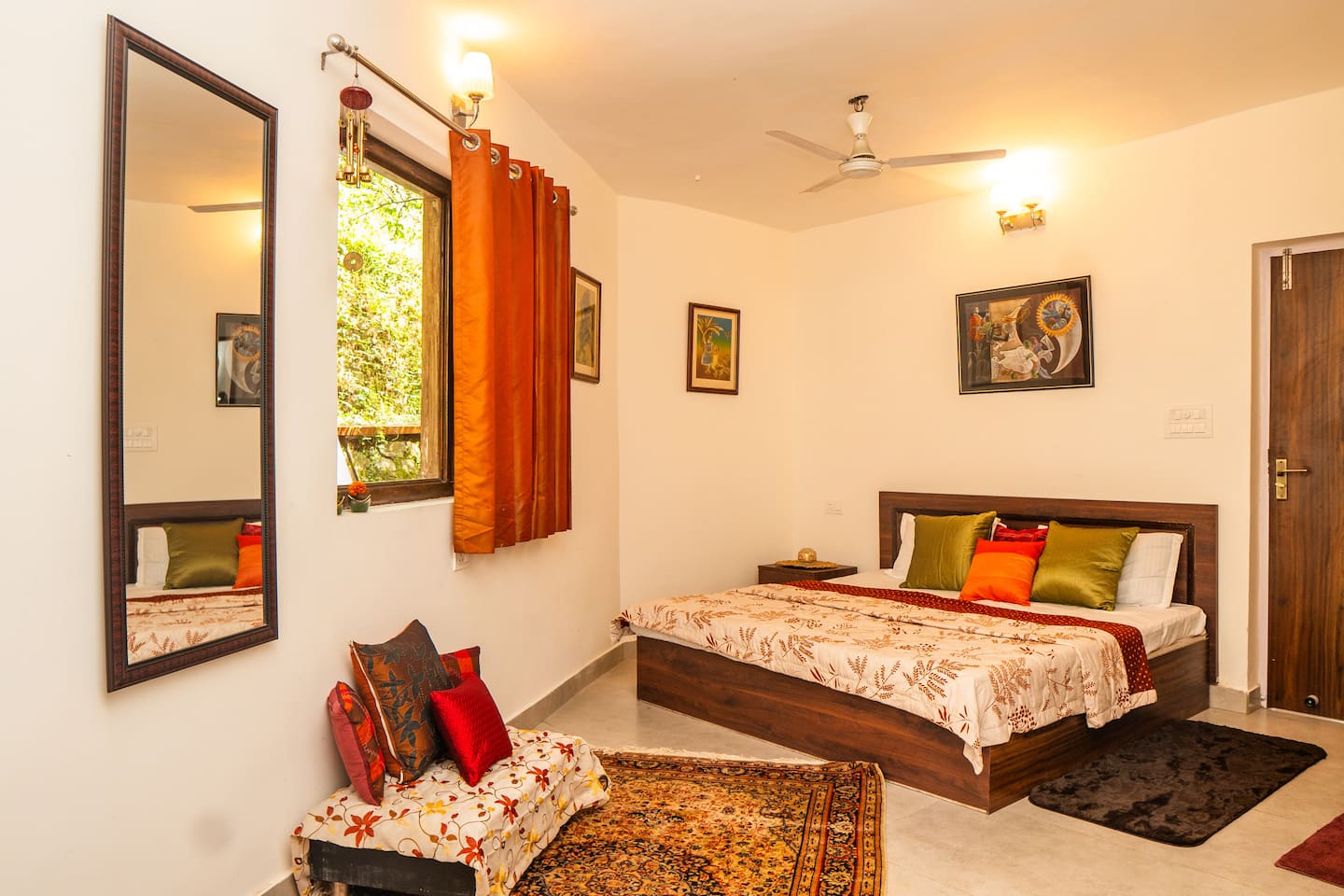 Ground floor bedroom with wooden bed, mirror and garden-facing window