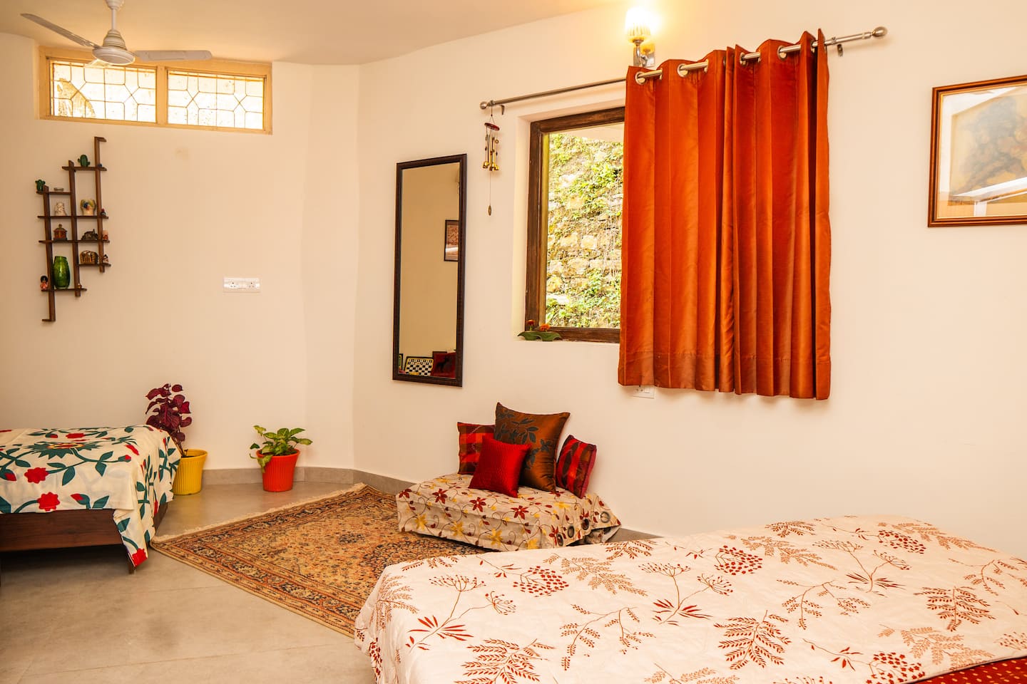 Bedroom with two beds, rug and hill-facing window