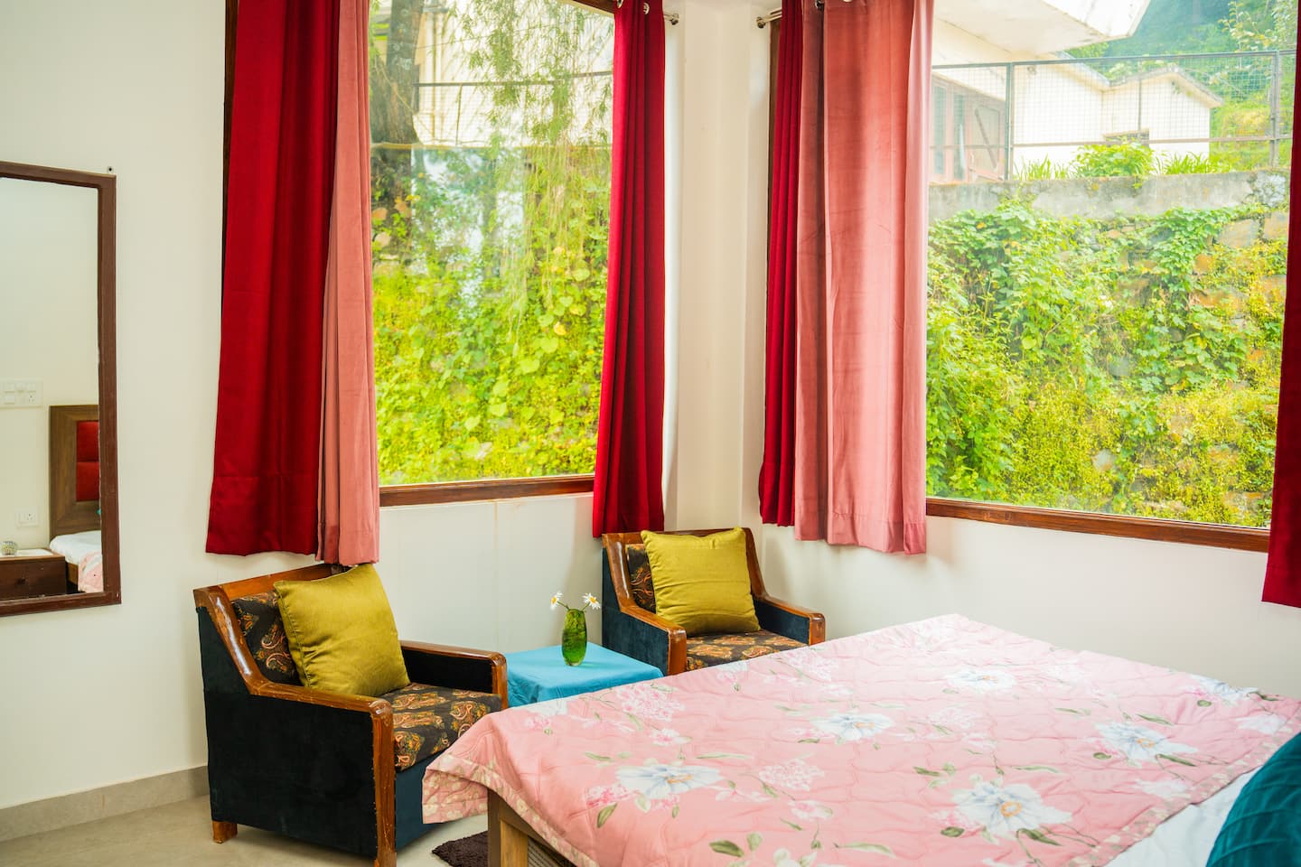Sitting corner with velvet chairs beside a big garden window